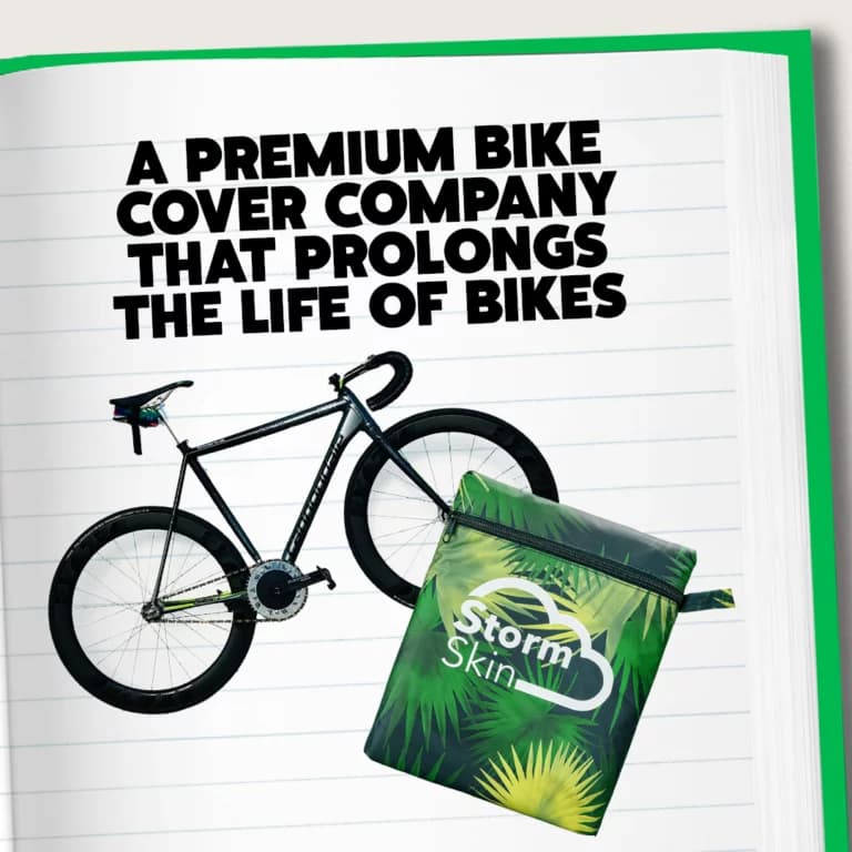 Bike with a cover package on a notebook page, featuring text about a premium bike cover company called Storm Skin.